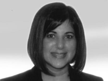 Nujma Bond with a bob haircut smiling