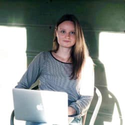 Catherine Phillips looking up from a laptop