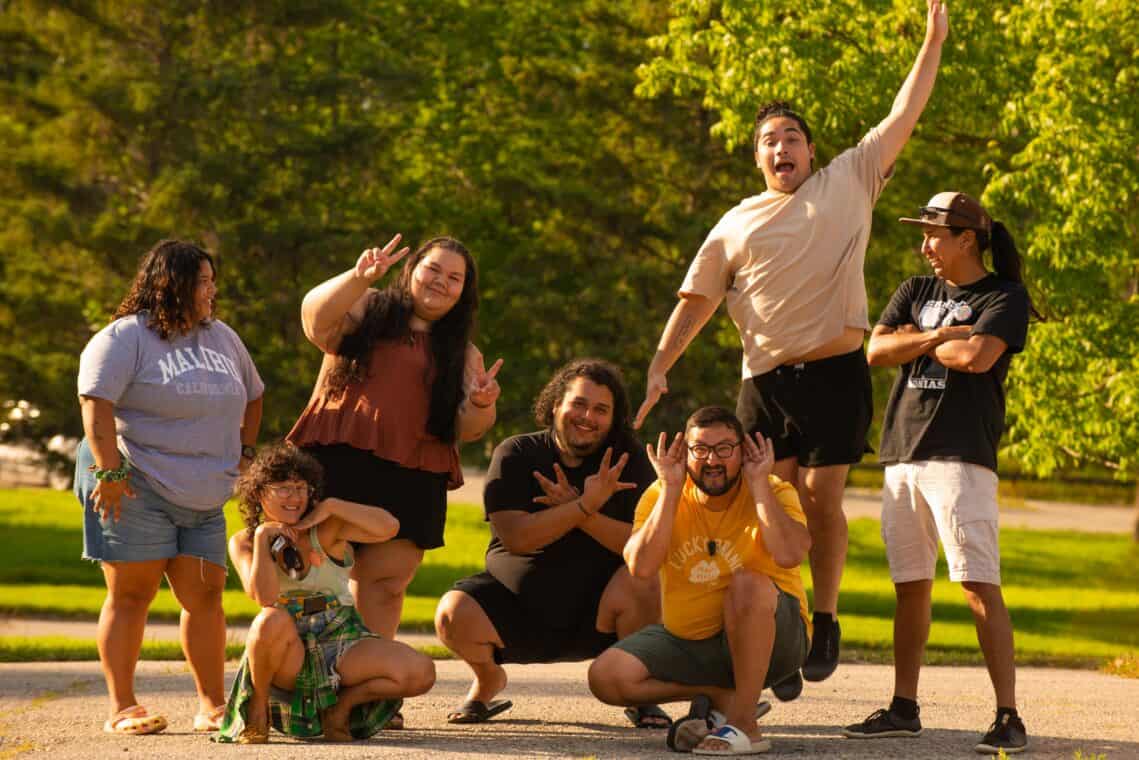Several people outside posing with smiles.