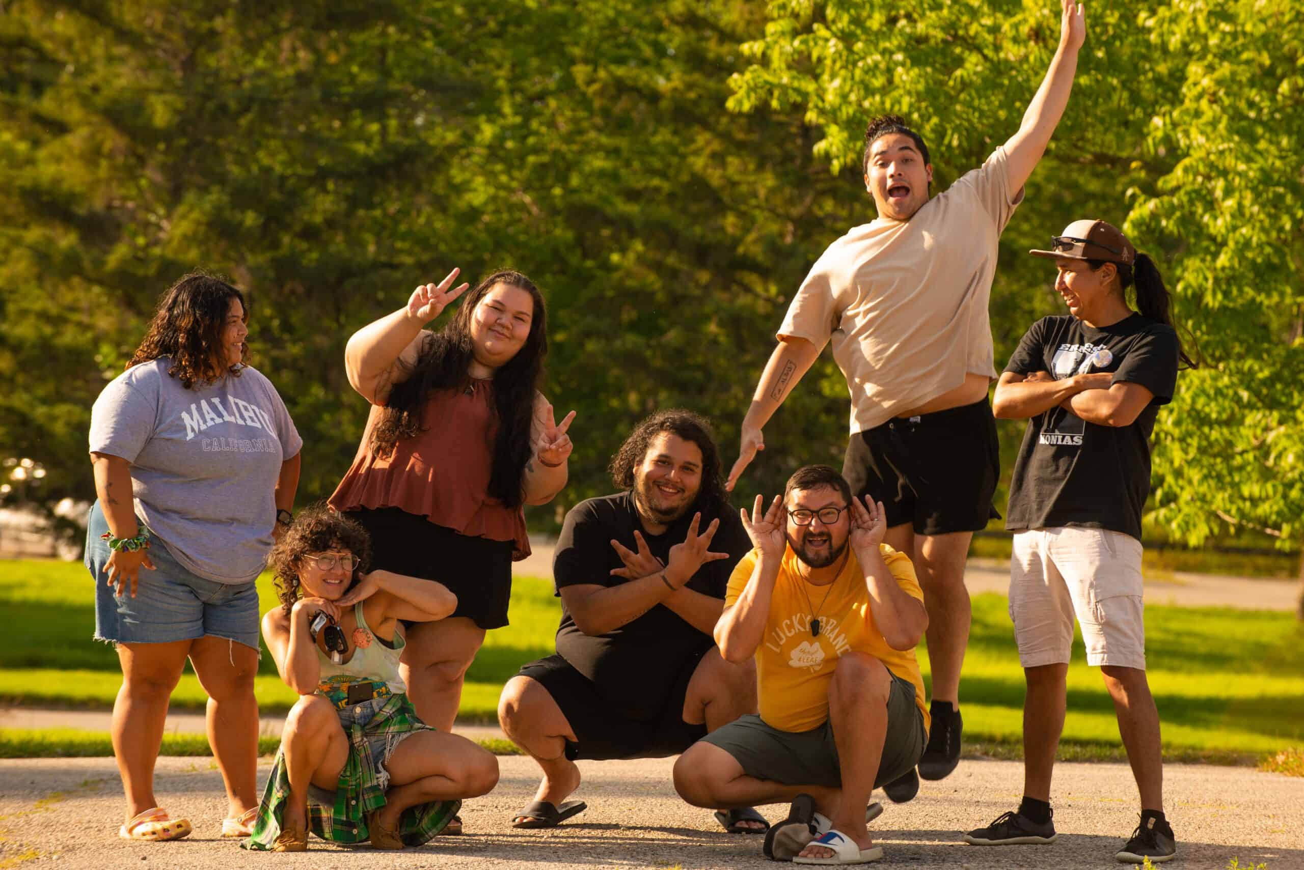 Several people outside posing with smiles.