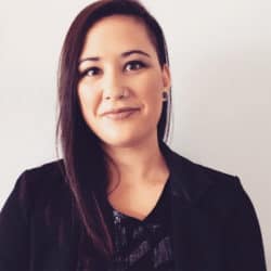 Jacqueline Stol with long hair and dark jacket covering sequent top