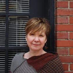 Leslie Wright in front of a brick wall