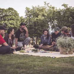 People picnicking in the field behind Maison Mère