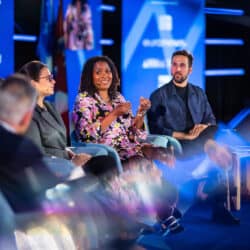 Five panelists on a stage