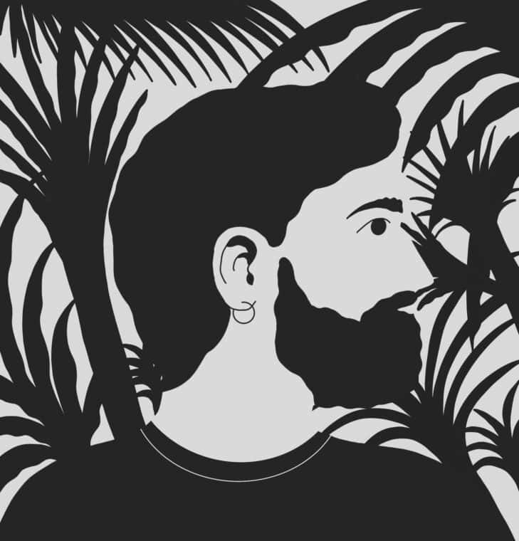 Side profile of man with hoop earring and beard.