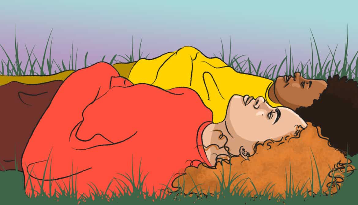 Two people laying in grass, looking up at the sky.
