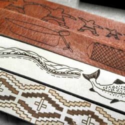 Four belts with images drawn into the leather.
