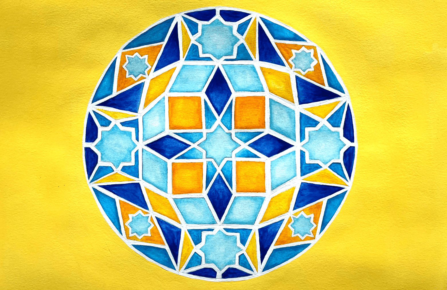 Mandala design in yellows, blues and orange.